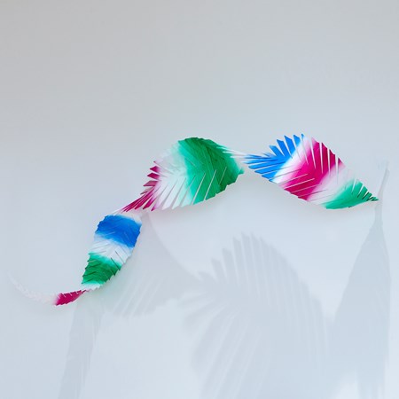 curling twisting abstract feather with soft painted bands in green white blue and magenta hand made from aluminium and painted with aqua car paint