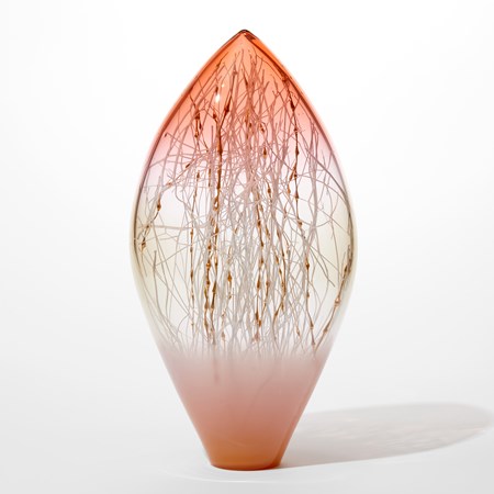transparent artwork in a tear shape with pointed top opaque pink bottom half fading to clear then fading to transparent peachy pink at the top with fine canes in white and gold with bobbles filling the interior space