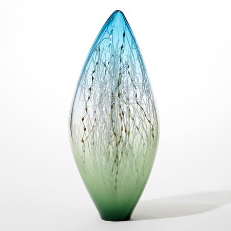 tall slender ovoid glass sculpture with pointed transparent aquamarine top clear middle fading to opaque forest green base with the inside filled with a myriad of fine straight and undulating canes in ochre blue teal and brown