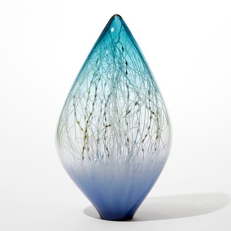 transparent ovoid glass sculpture with opaque lilac base fading to clear then fading to transparent turquoise with pointed top and interior filled with fine straight and undulating canes in white brown ochre and blue