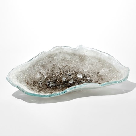 oyster shell shaped long artwork in white with soft green colouring to the edges with the interior filled with bronze coloured crystals increasing in size to the centre hand made from glass