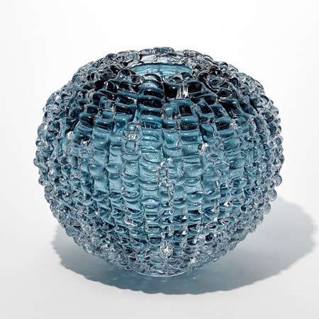 spherical hollow glass sculpture made from small rectangular pieces in light blue