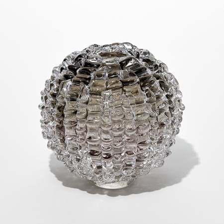 round transparent grey bronze vase with undulating ridged exterior and small top opening hand blown from glass