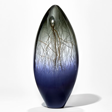 oblong shaped glass sculpture with wire interior in dark blue, green and gold colours