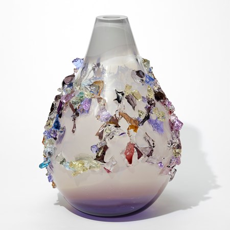 teardrop shaped opaque vase with milky white body fading to rich purple at the base and soft grey at the top with the wide central band on the surface of organic crystal shards in bronze brown yellow pink and aubergine hand made from glass