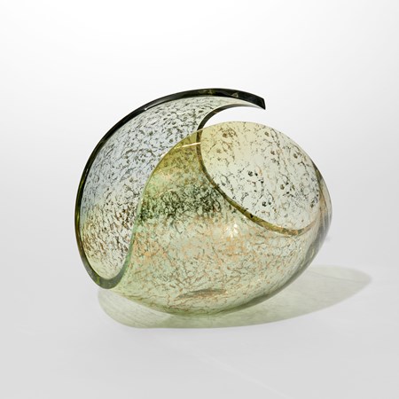 transparent lime green ovoid with cut away section leaving a traversing looping rim hand blown from glass with an exterior gold pattern sponged onto the surface