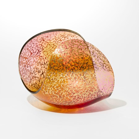 egg shaped form with large cut away section leaving a curving sweeping rim hand blown from transparent pink glass and with a mottled gold pattern on the outside