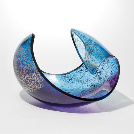 laying down ovoid sculpture with cut way section hand blown from turquoise and purple glass with a sponged platinum texture on the outside