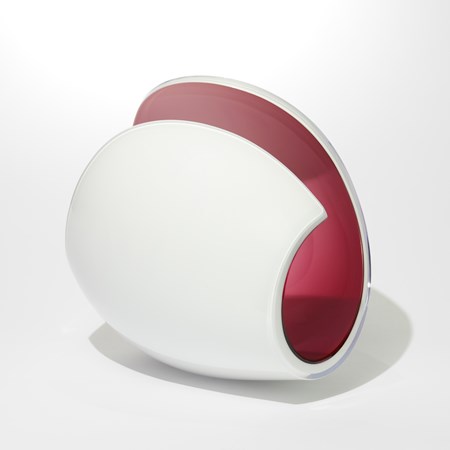 simplified shell like sculpture with an opaque white exterior and rich cerise pink interior with a sweeping curling rim ending in a point handmade from blown glass