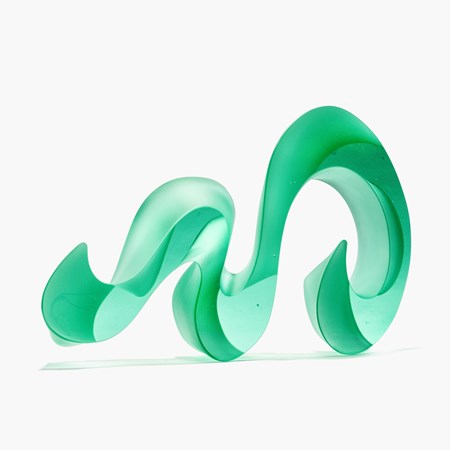 curling undulating bright jade lime green opaque sculpture with two flat sides and two curling sides following the movement of the piece as it waves and snakes along in form hand made from cast glass