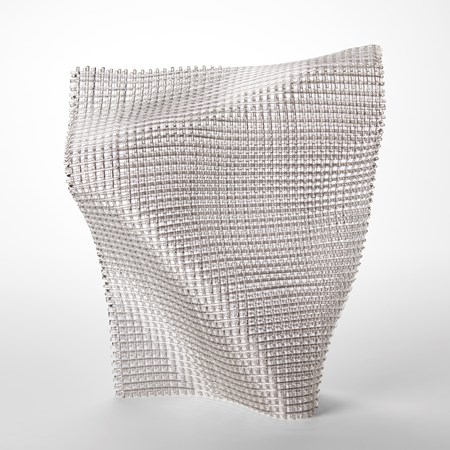 standing flexing woven form with the appearance of open weave fabric with a shimmering silver finish hand made from fused glass and nickel chromium