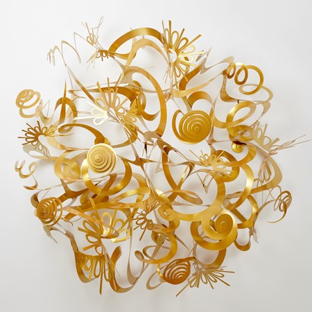 organically rounded and domed wall installation created from rings loops swirls and ribbons of matt gold power coated aluminium with the material equalling in quantity to the negative space within the artwork