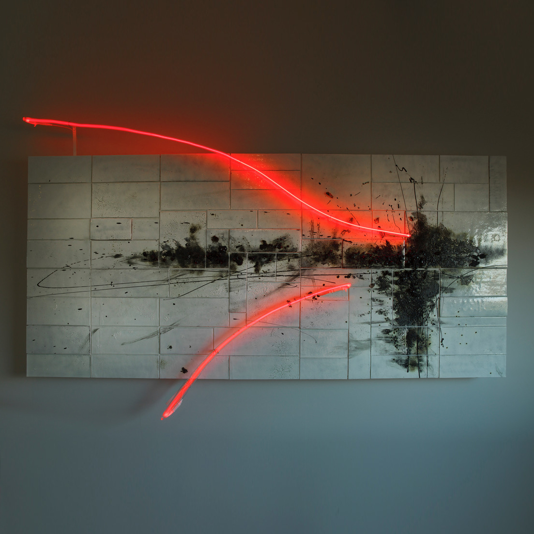 white landscape panel with tiled effect and a black smudged organic mass across the middle and two sweeping lines in bright neon hand made from glass