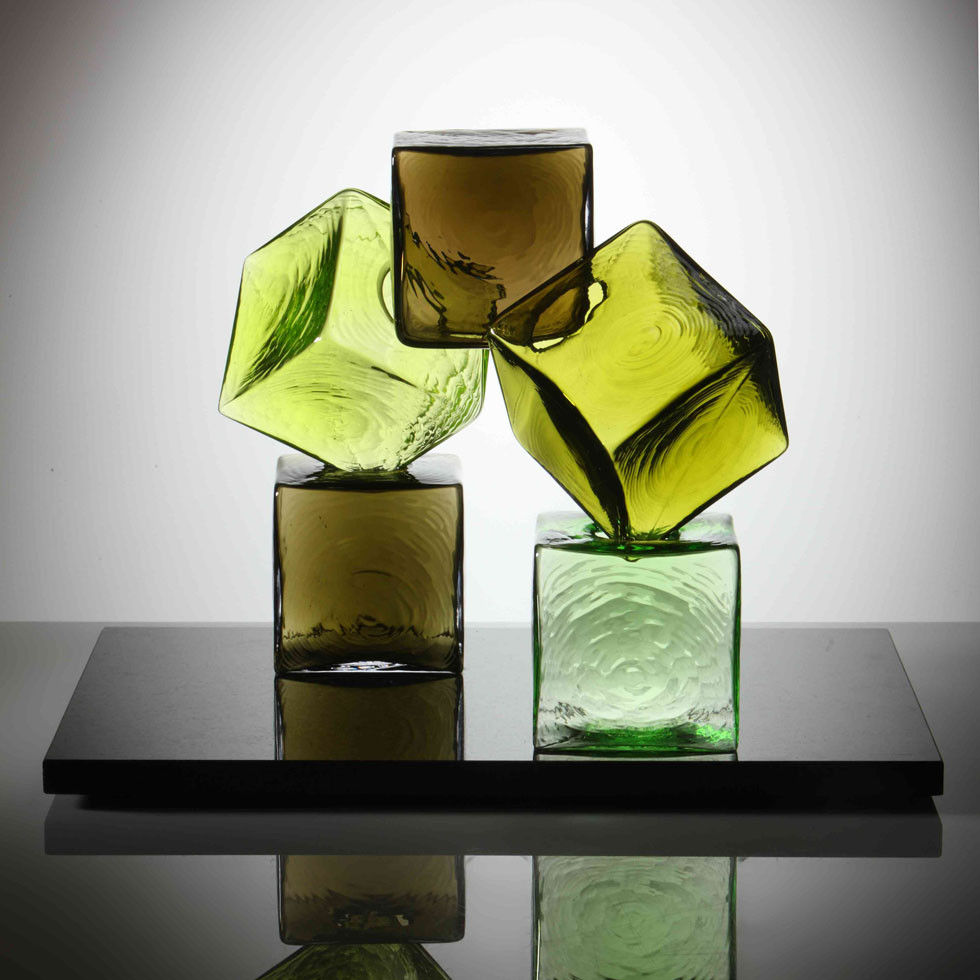 artwork of cubed glass pieces in green and brown colours on black rectangular base