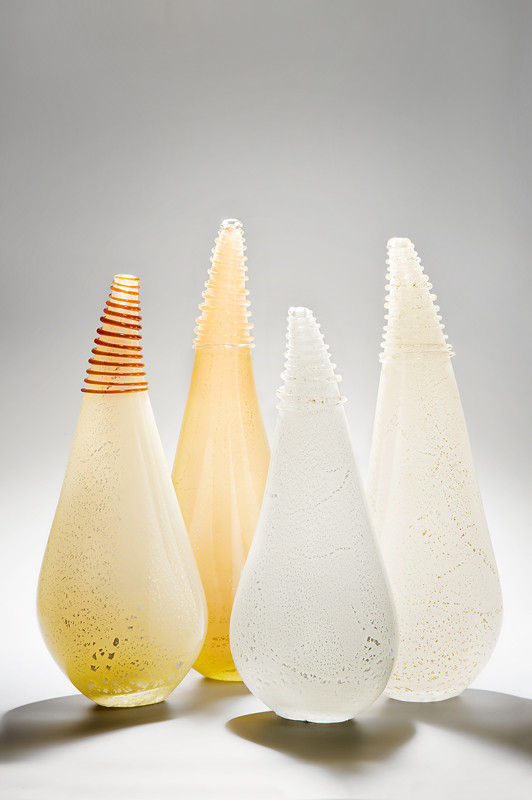 four art glass vessel sculptures in shades of white and gold