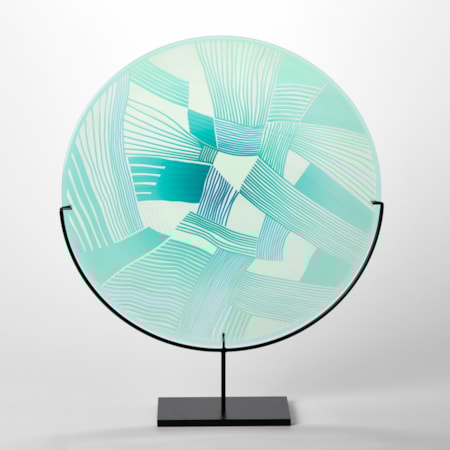 aqua and jade translucent round glass rondel with abstract patchwork landscape cutting on the surface handmade from glass and presented on a matt black steel stand
