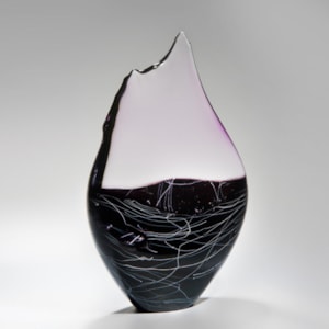 blown and sculpted glass ornament in abstract teardrop shape in black clear and pink