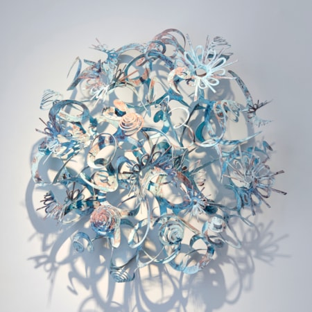 round wall mounted artwork consisting of spirals swirls curls and shapes all interlaced hand made from patinated brass with a verdigris finish