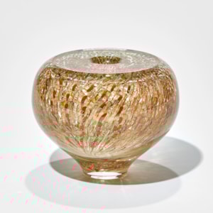 small round clear vase with top flat surface and tapered foot with trapped repeat surface pattern in gold brown orange salmon and amber hand made in glass