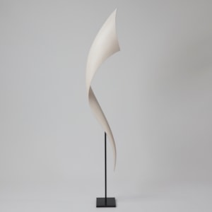 tapering curved white long vertical curling wooden sculpture held aloft on a simple black steel stand