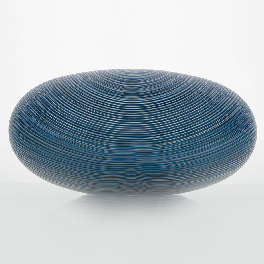 rounded oval glass vessel sculpture with fine lined pattern in blue and grey 