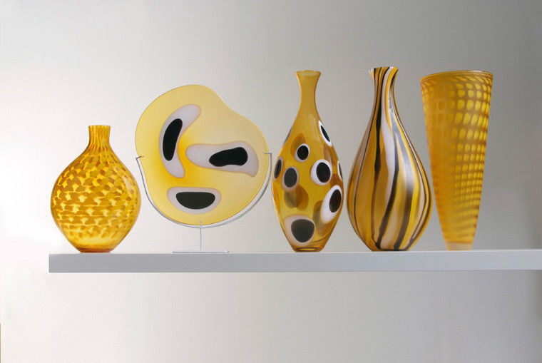 five handblown glass vases in shades of yellow with various patterns