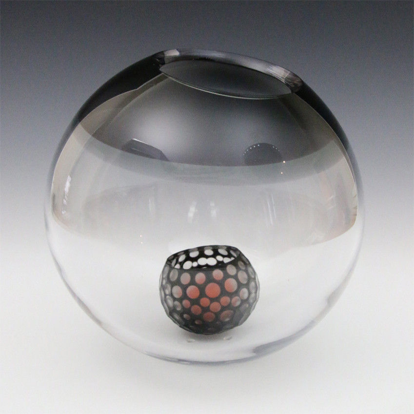 art glass sculpture of small coloured lampshade inside larger clear glass ball