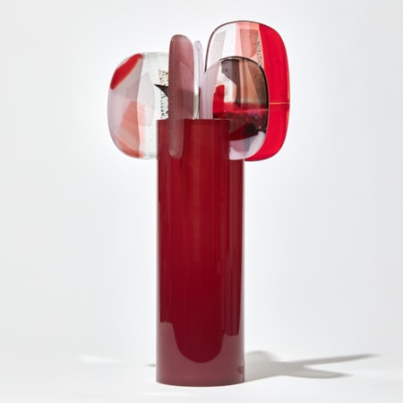rich oxblood red cylinder with five finials perched on the rim with abstract patterns in aubergine red and pink hand made from blown and fused glass by amy cushing