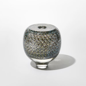 round transparent vase with small circular repeat pattern trapped inside in dark sage green and turquoise hand made from blown glass