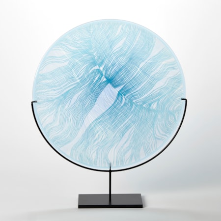 round glass rondel in soft light blue aqua and jade with front cut and etched linear patterns held aloft on a matt black stand