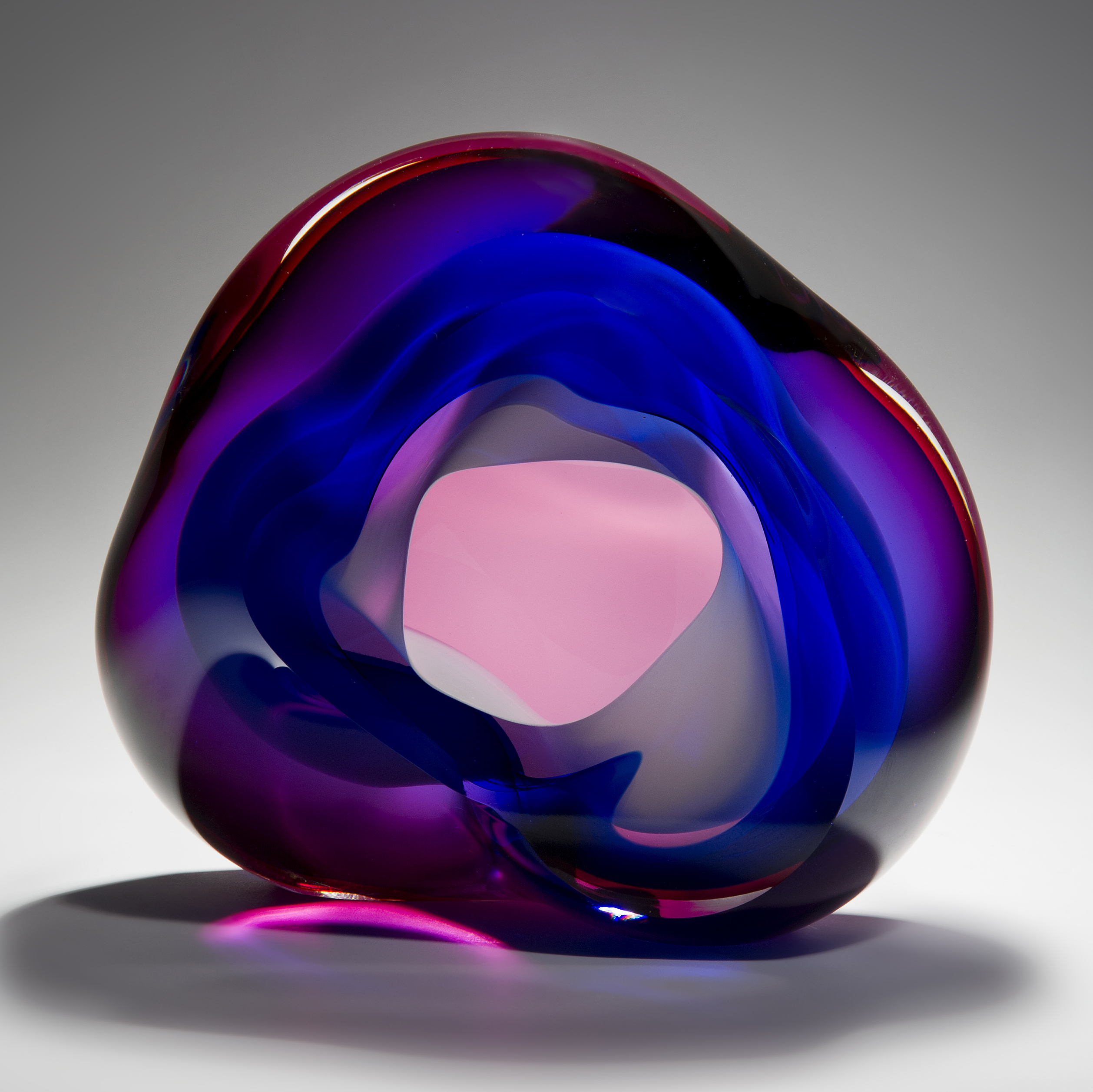 modern vug shaped abstract art glass sculpture in neon pink and dark blue