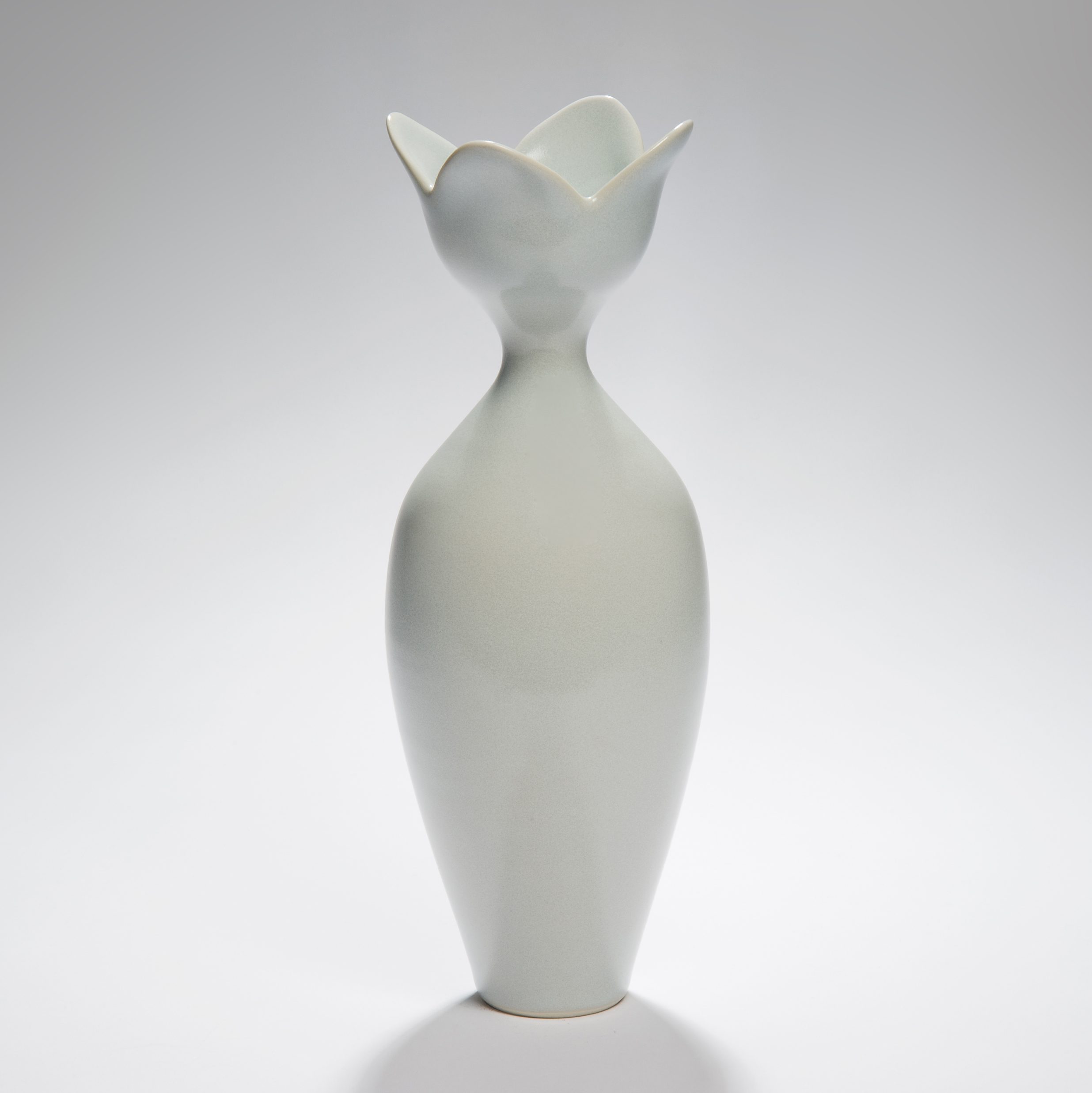 tall pale blue ceramic vase sculpture with flower shaped rim