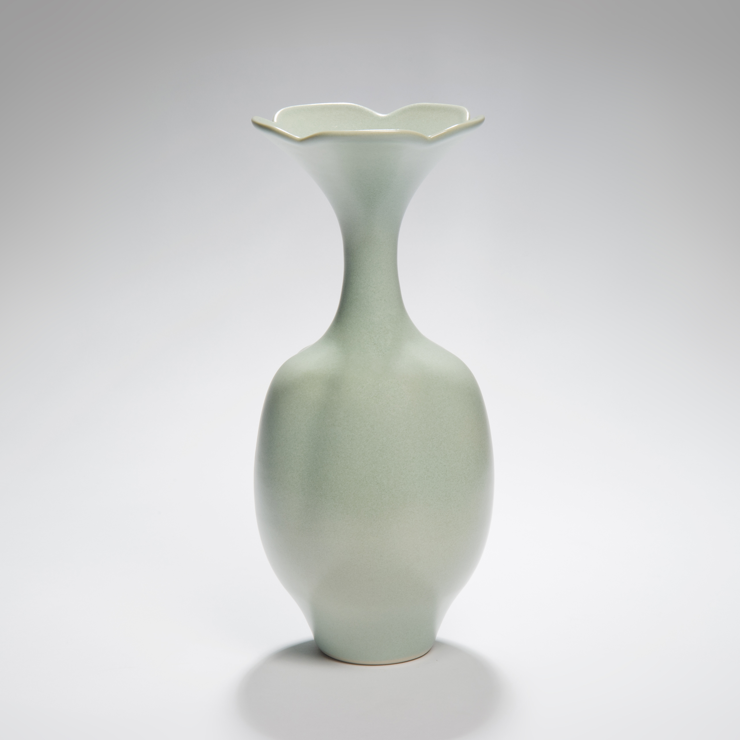 tall melon coloured porcelain vase sculpture with foliate rim