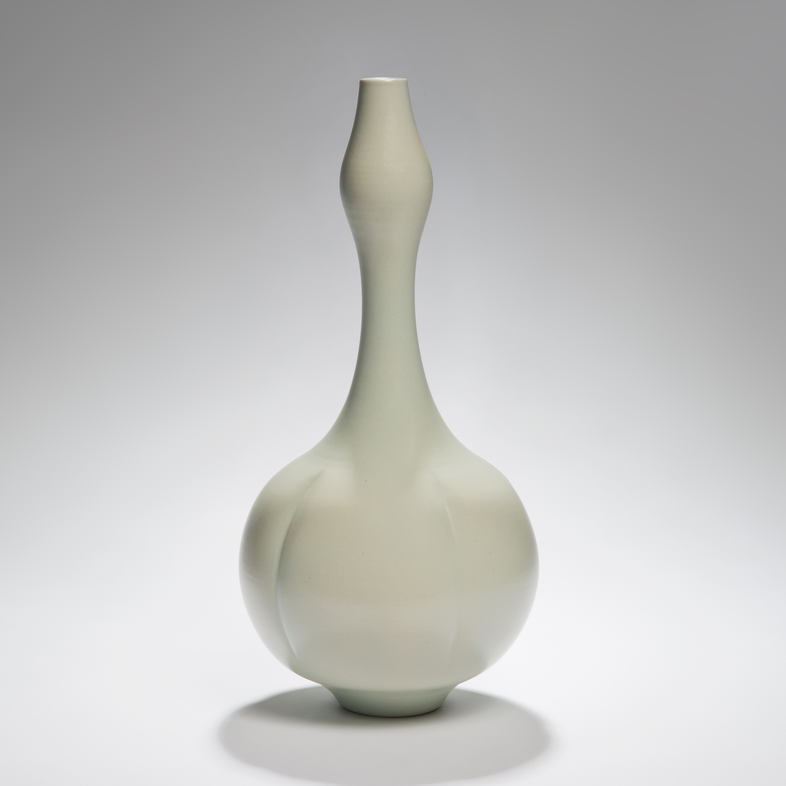 porcelain vase sculpture in green with wide botton and thin top