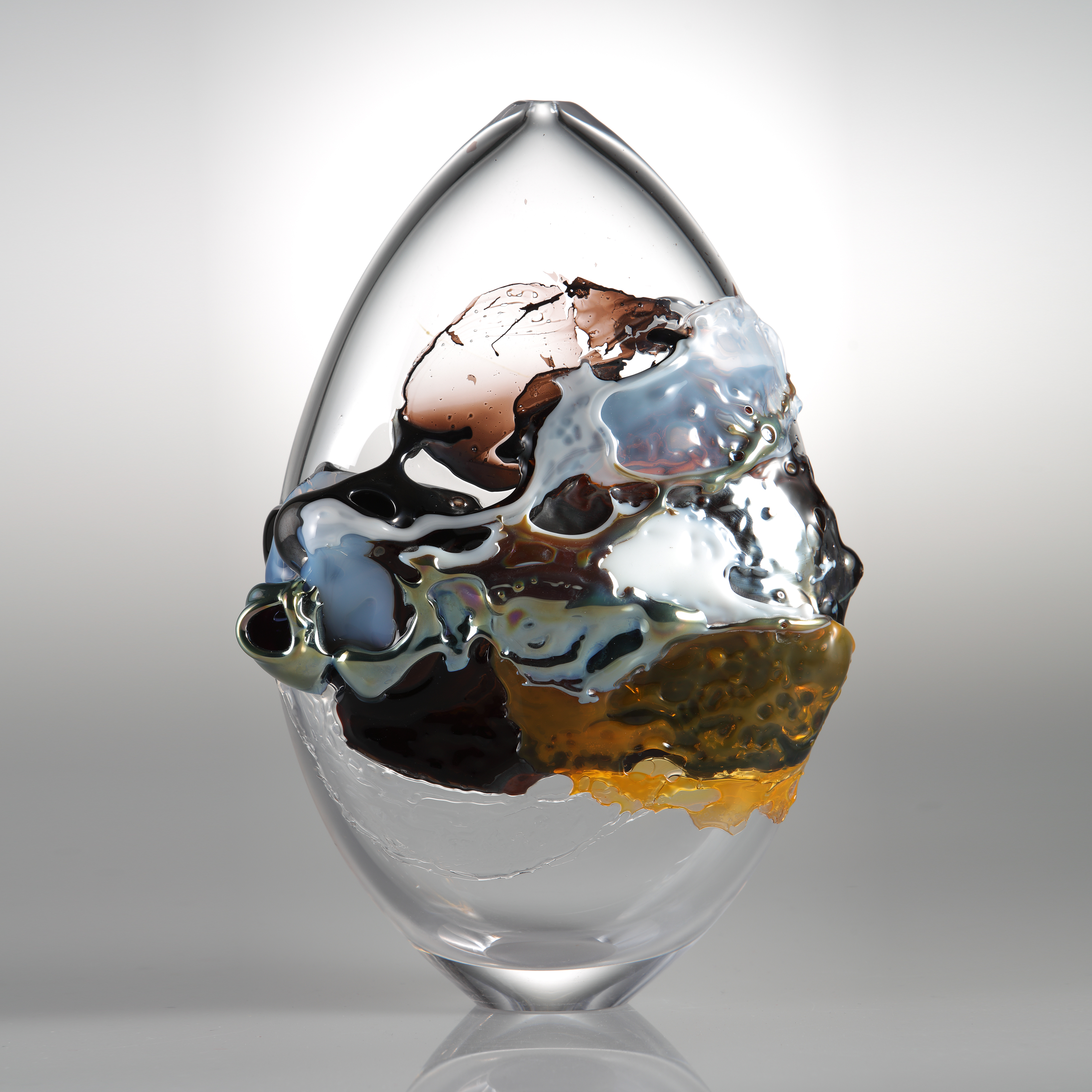 modern oval shaped art glass sculpture with graffiti like external decoration