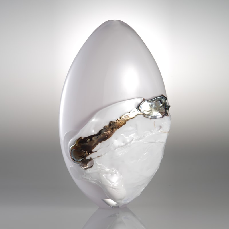orb shaped art glass sculpture in white with black and gold splashes