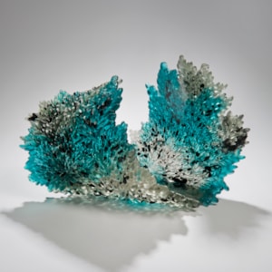 art-glass sculpture of curled leaf in turquoise black and crystal
