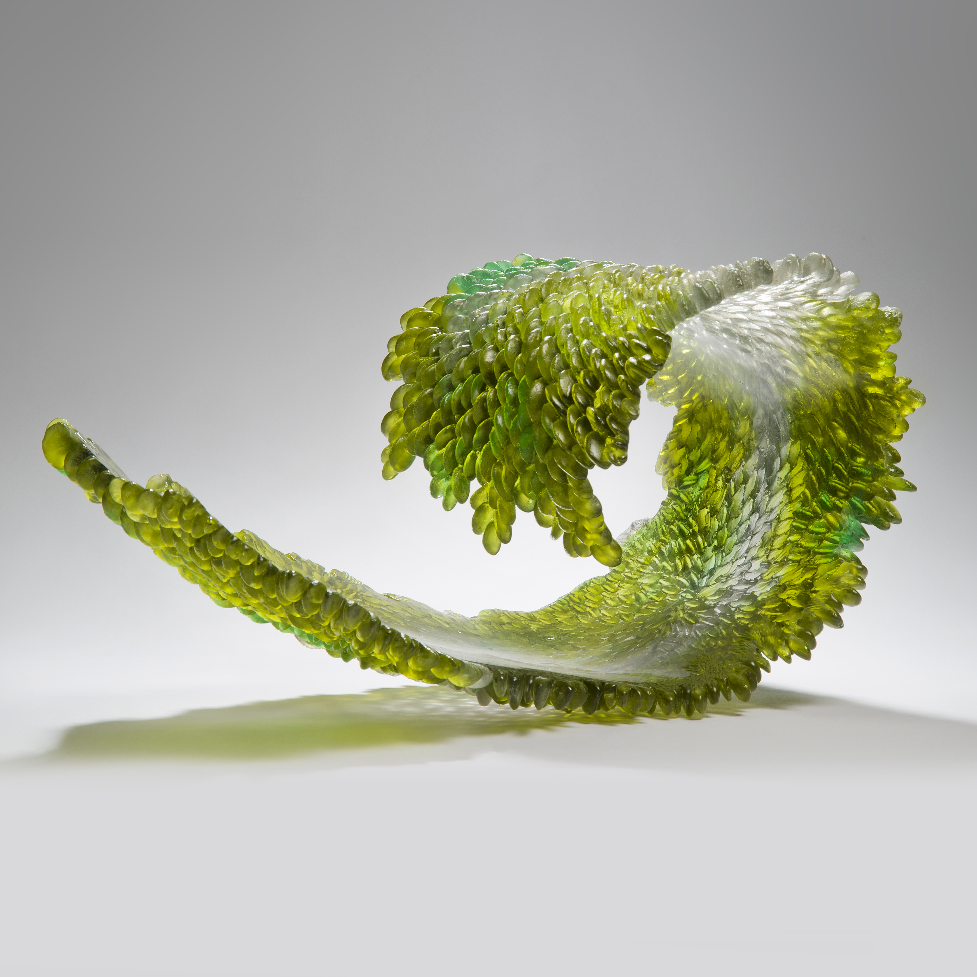 modern art glass sculpture of curled leaf in green