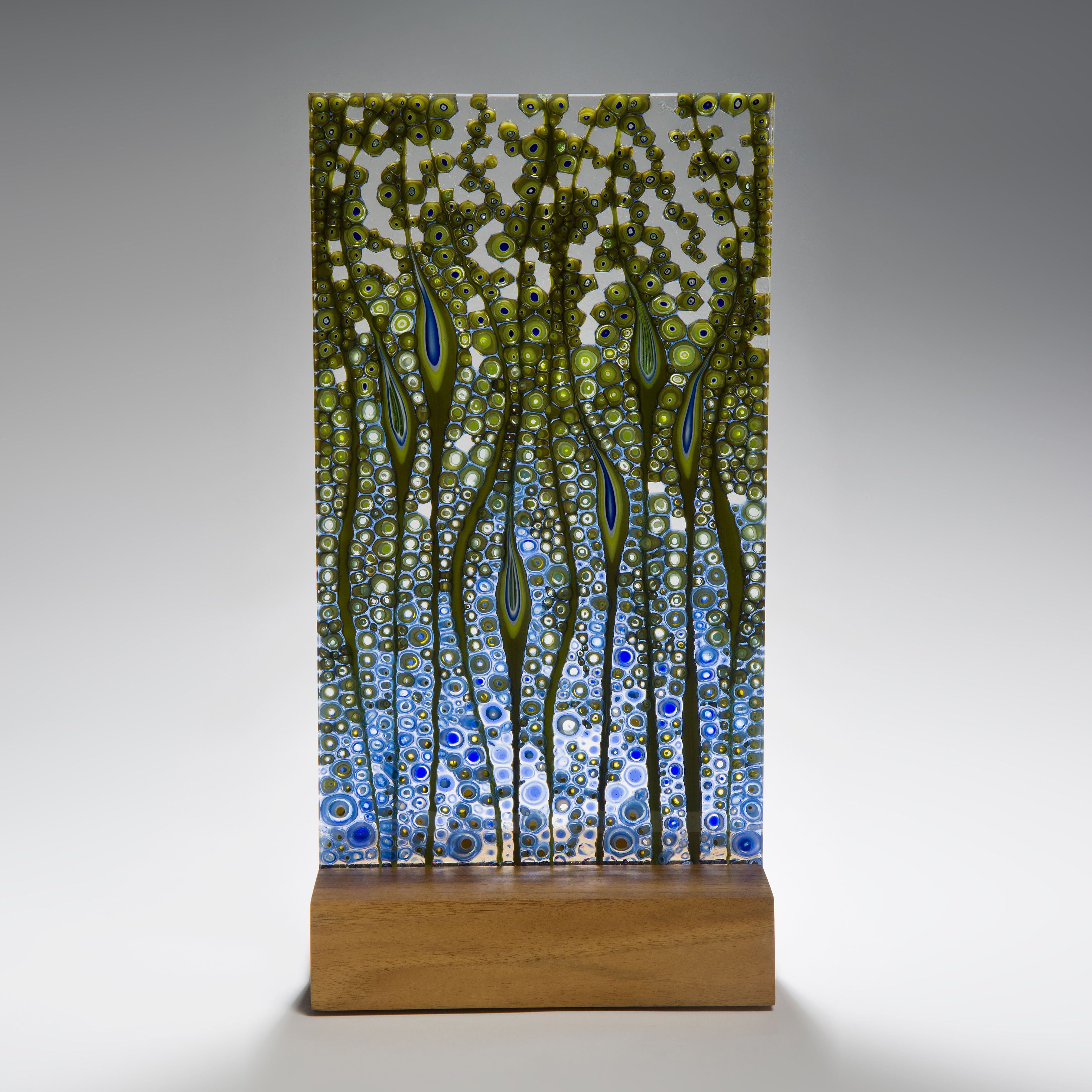 fused glass panel artwork in green and blue on wood base