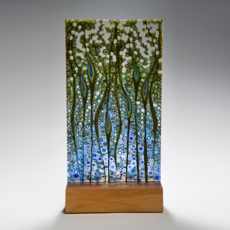 fused glass panel artwork in green and blue on wood base