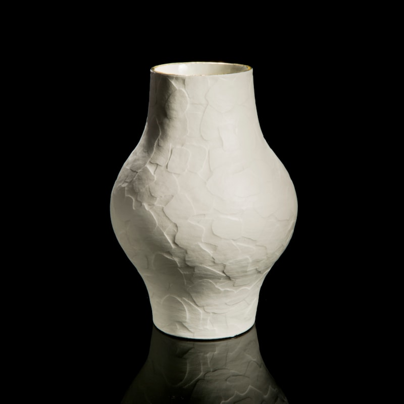 porcelain ceramic sculptured vessel with wider midriff