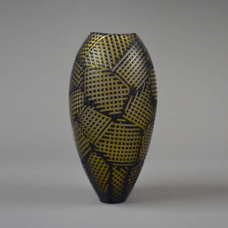 tall glass vase sculpture in black with gold checked patterns
