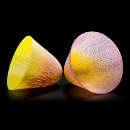 two art glass cone shaped vessels in yellow and pink