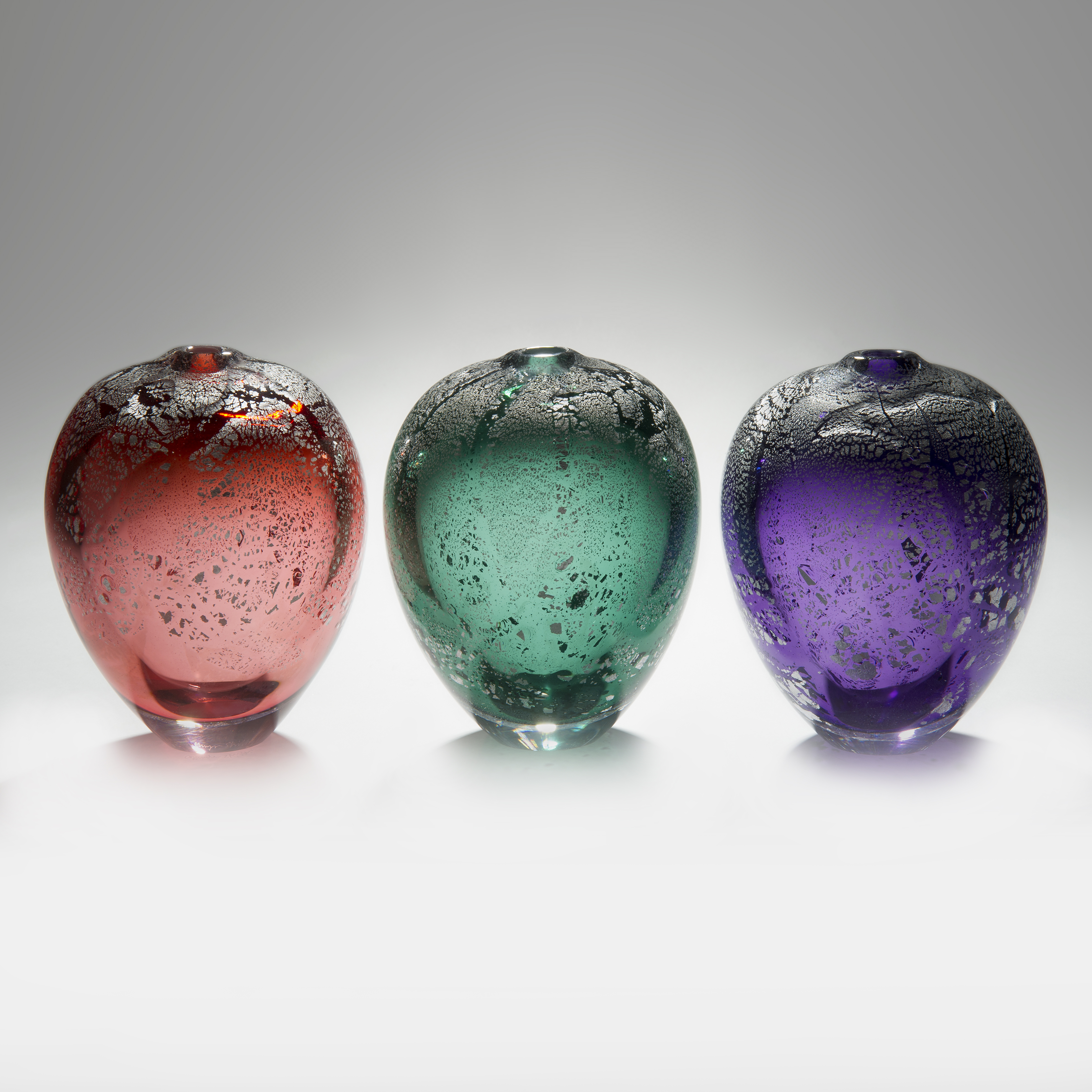 colourful apple shaped glass sculptures with silver speckles