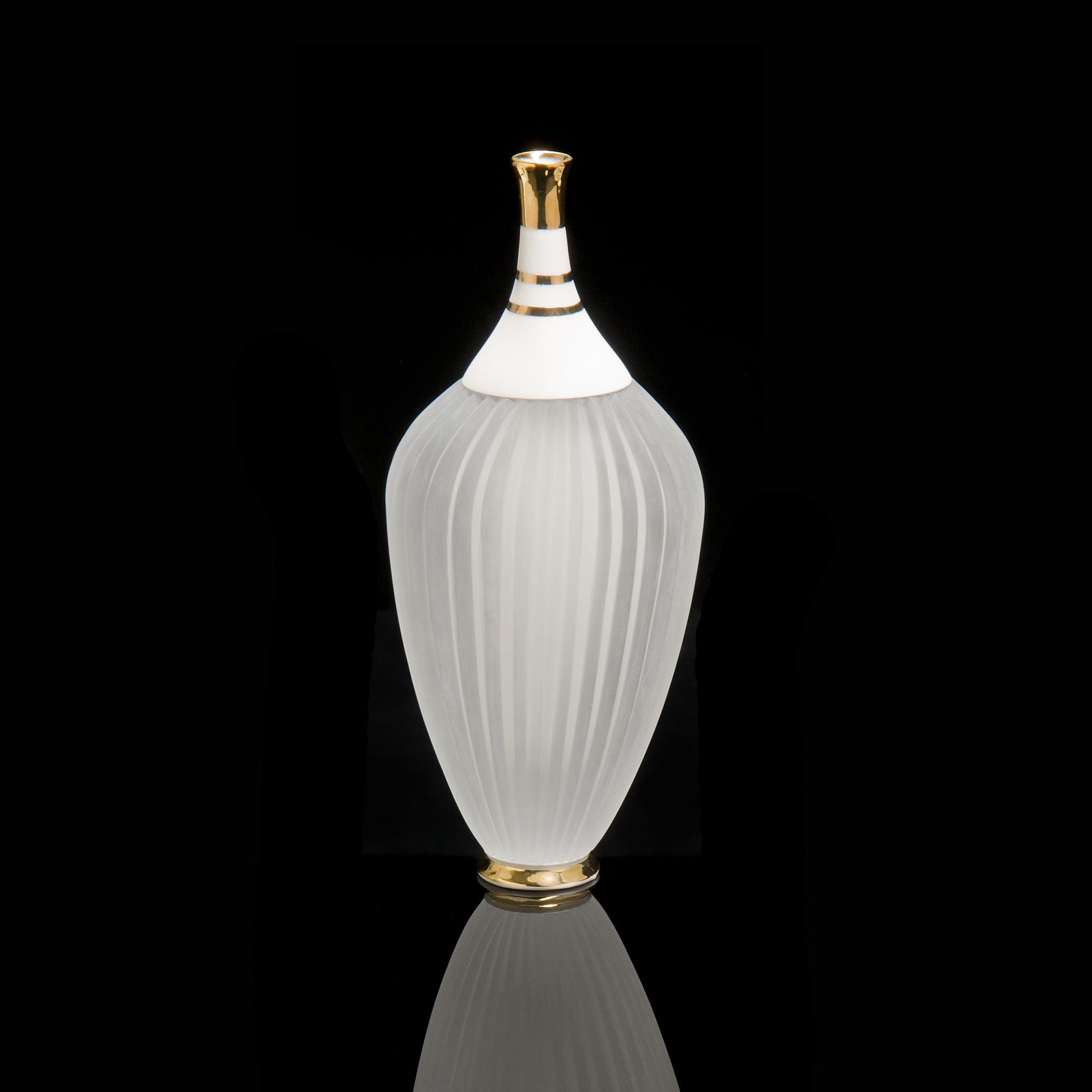 tall ceramic and glass art sculpture of a teapot in white wth gold trim