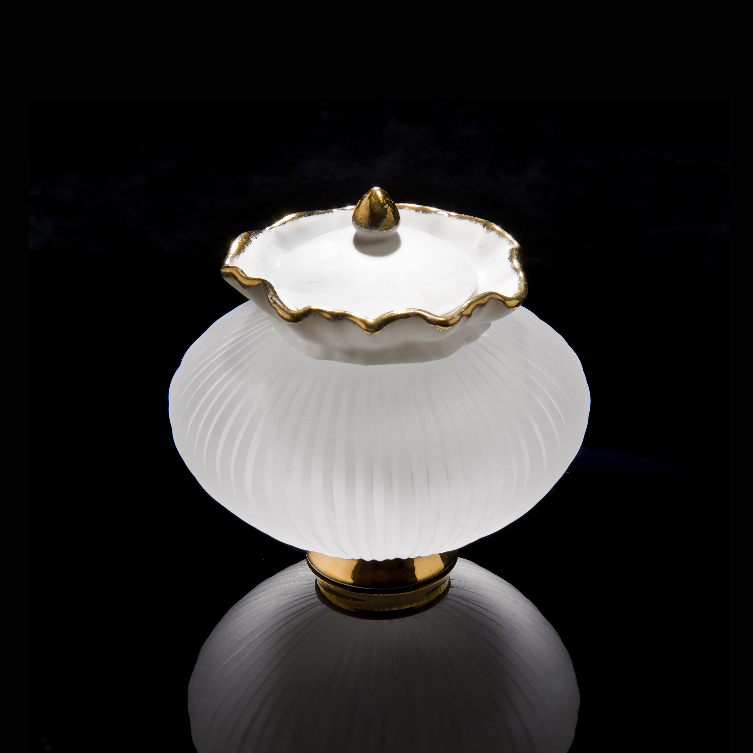 small glass and porcelain artwork of teapot with gold base and trim