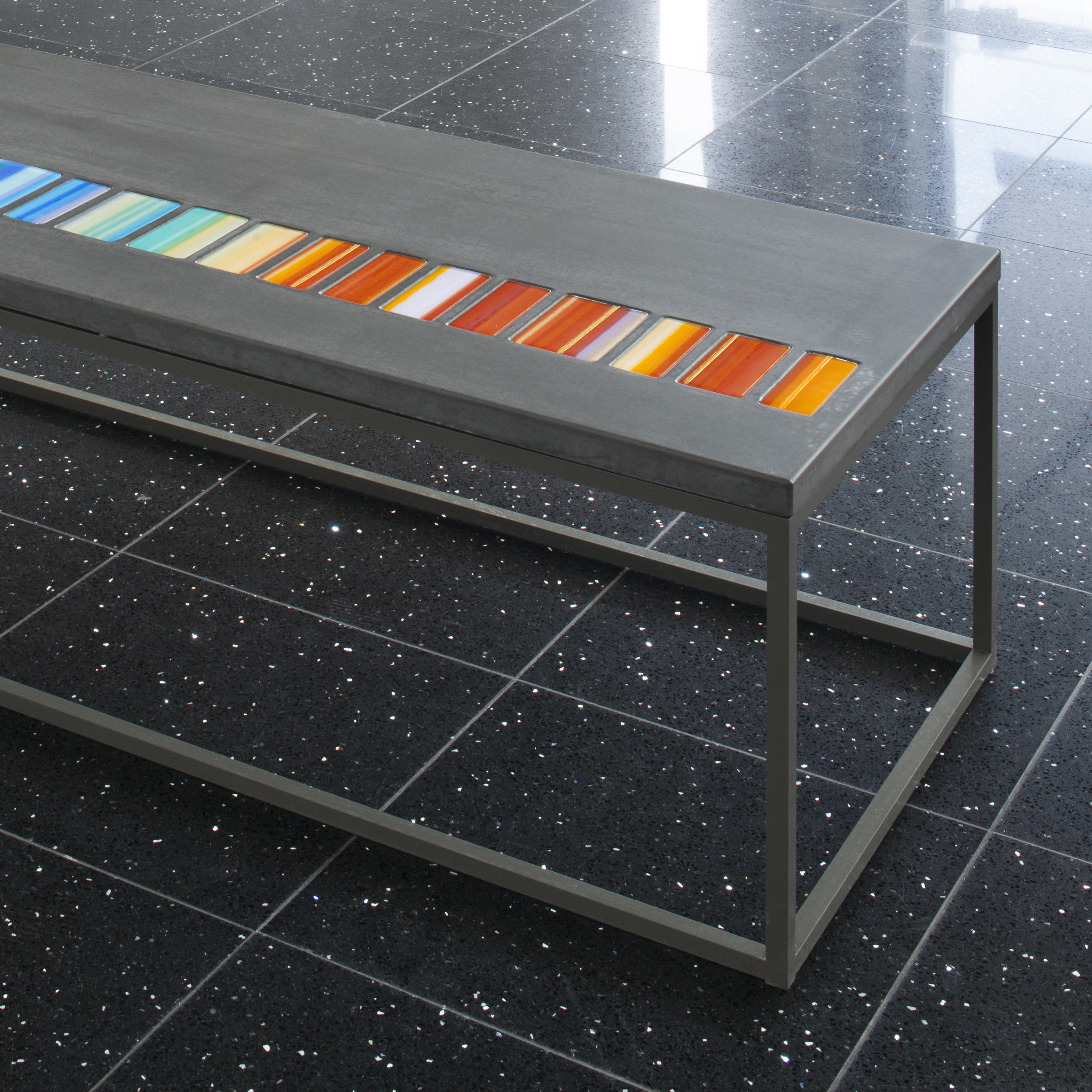 coffee table made from steel and concrete with pastel coloured art glass inlays
