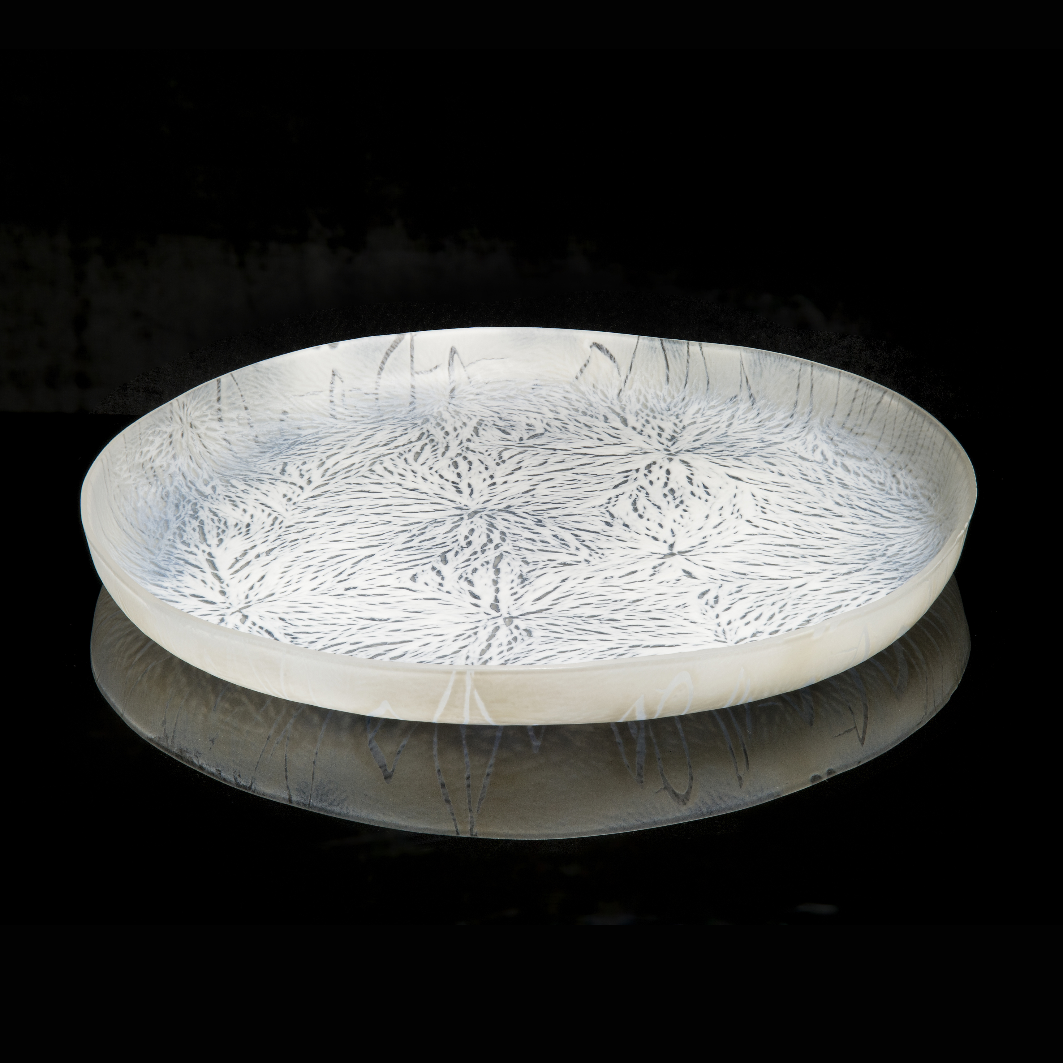 modern art glass sculpture of a large plate in white and black