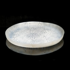 modern art glass sculpture of a large plate in white and black