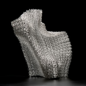 woven art glass sculpture in silver resembling wire mesh structure